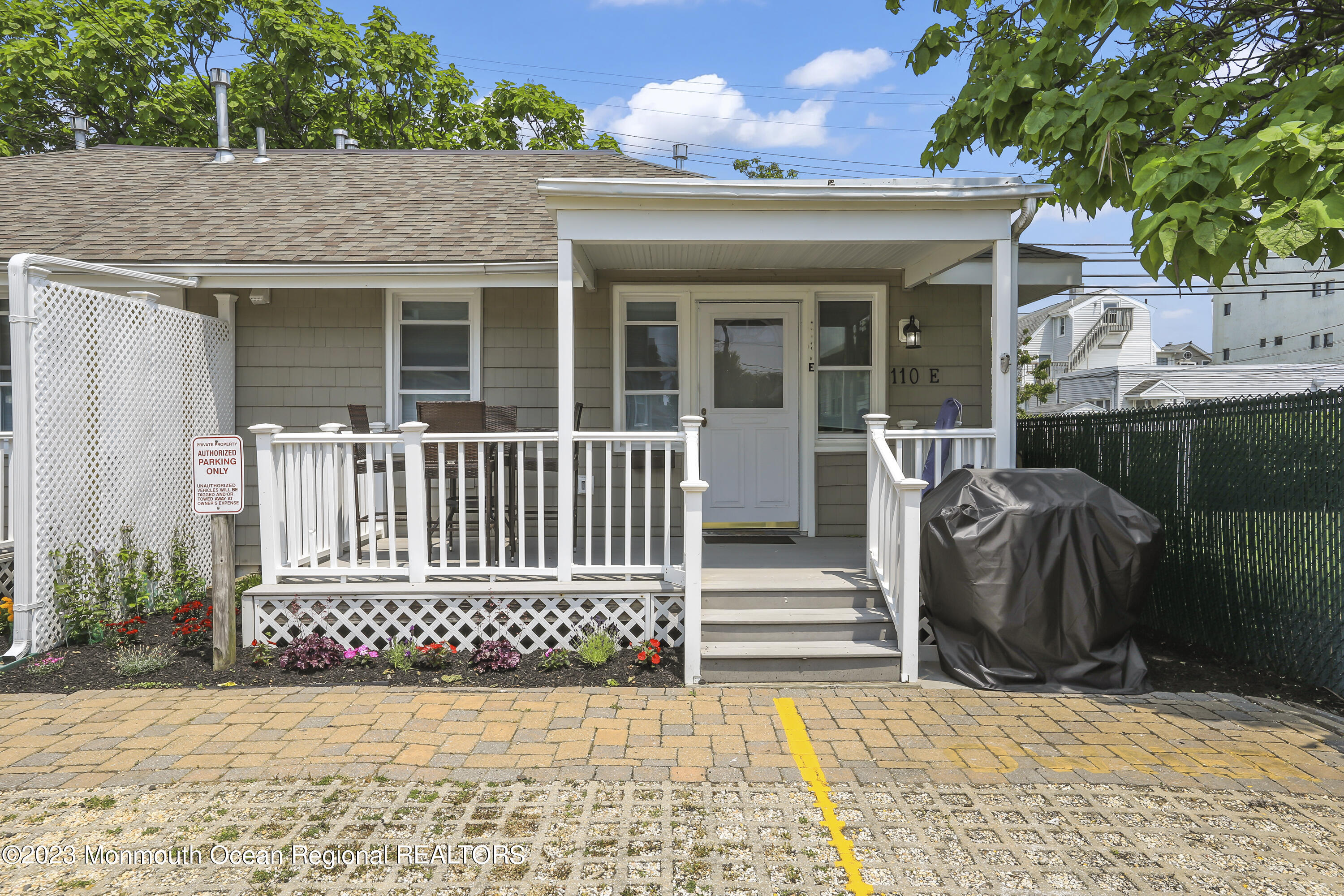 a view of a house with a wooden bench