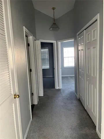 an empty room that has a large mirror and door