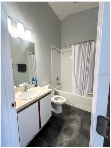 a bathroom with a double vanity sink toilet and mirror