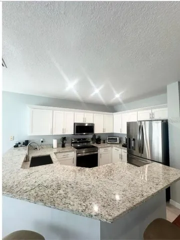 a kitchen with refrigerator and window