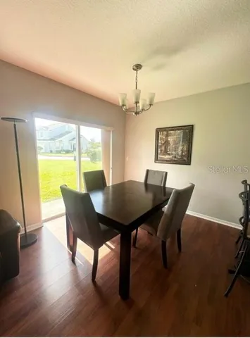 a view of a dining room with furniture and a window