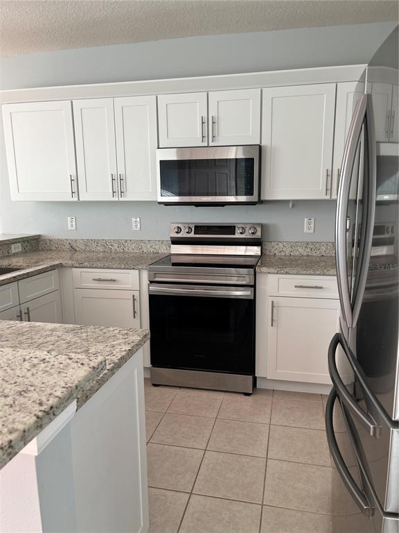 6407 Barksdale Way Riverview, FL 33578 - Photo 6 of 18 a kitchen with granite countertop a stove sink and cabinets