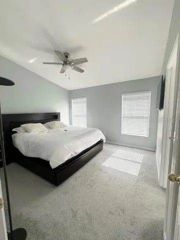 a bedroom with a bed and window