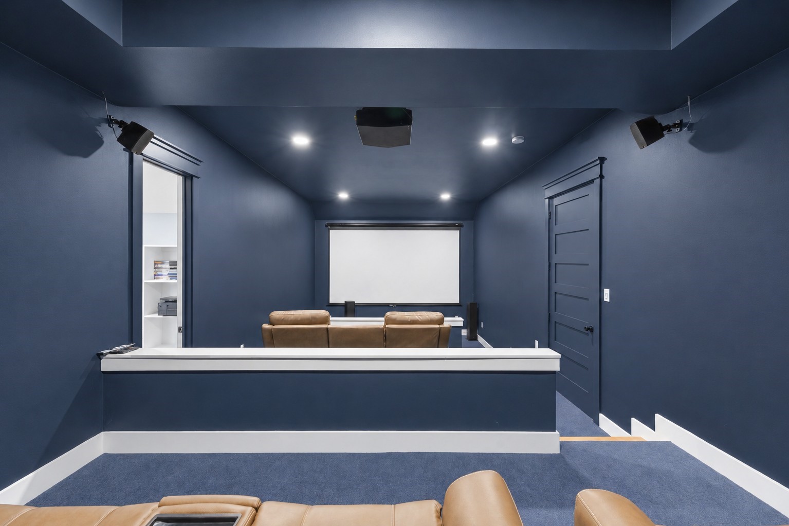 4607 Clayhead Road Richmond, TX 77406 - Photo 25 of 49 Immersive media room designed for cinematic experiences with tiered seating and dedicated surround sound setup.