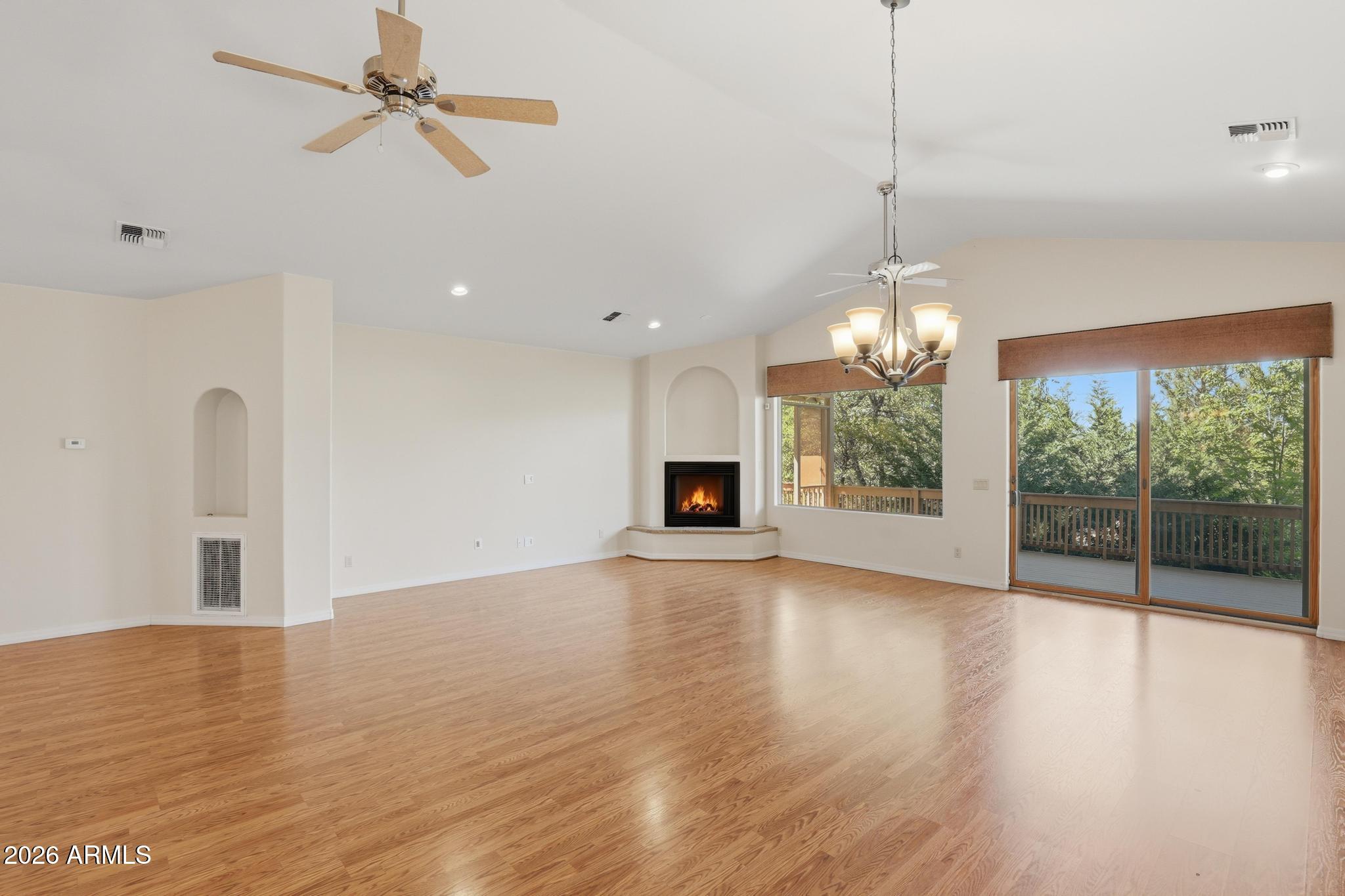 408 East Phoenix Street Payson, AZ 85541 - Photo 6 of 35 a view of a room with wooden floor a ceiling fan and windows