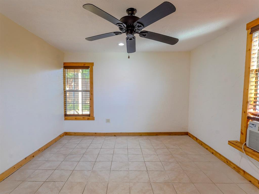 422 Washington Street Grapevine, TX 76051 - Photo 7 of 16 an empty room with windows and fan