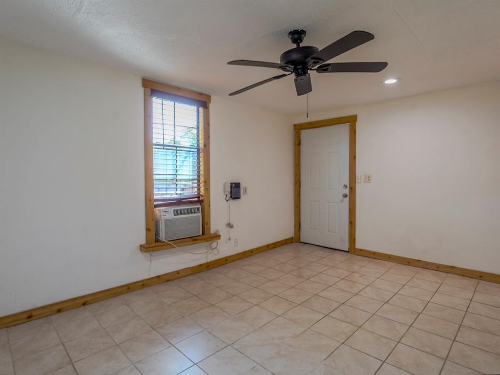 422 Washington Street Grapevine, TX 76051 - Photo 8 of 16 wooden floor in an empty room with a window