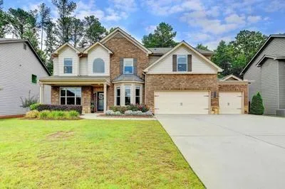 a front view of a house with a yard and garage