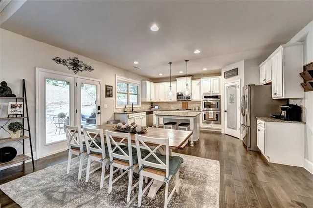 a view of a very nice looking dining room with a table and chairs