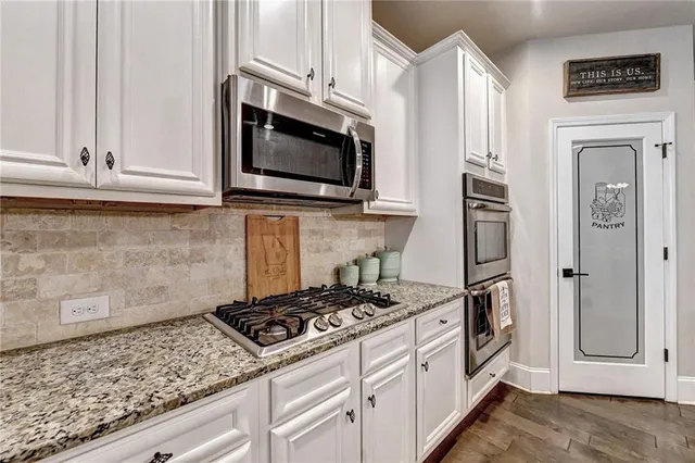 a living room with furniture a large window and a flat screen tv