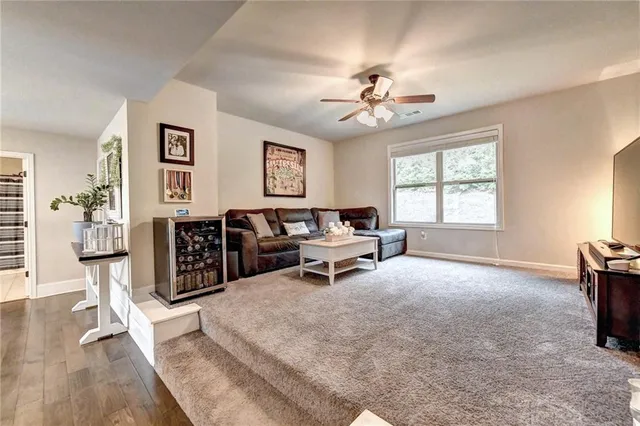 a spacious bedroom with a bed a couch and a flat screen tv