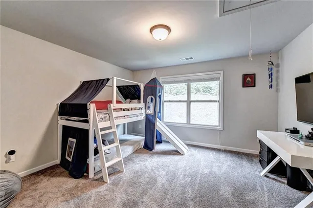 a view of a patio with table and chairs potted plants and large tree