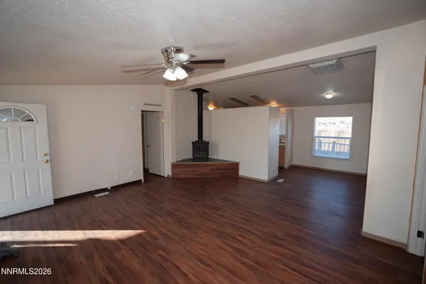 a view of a livingroom with wooden floor and a ceiling fan