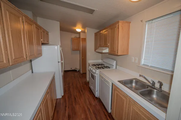 a kitchen with a sink a stove and refrigerator