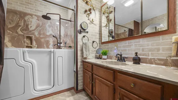 a bathroom with a sink mirror vanity and toilet