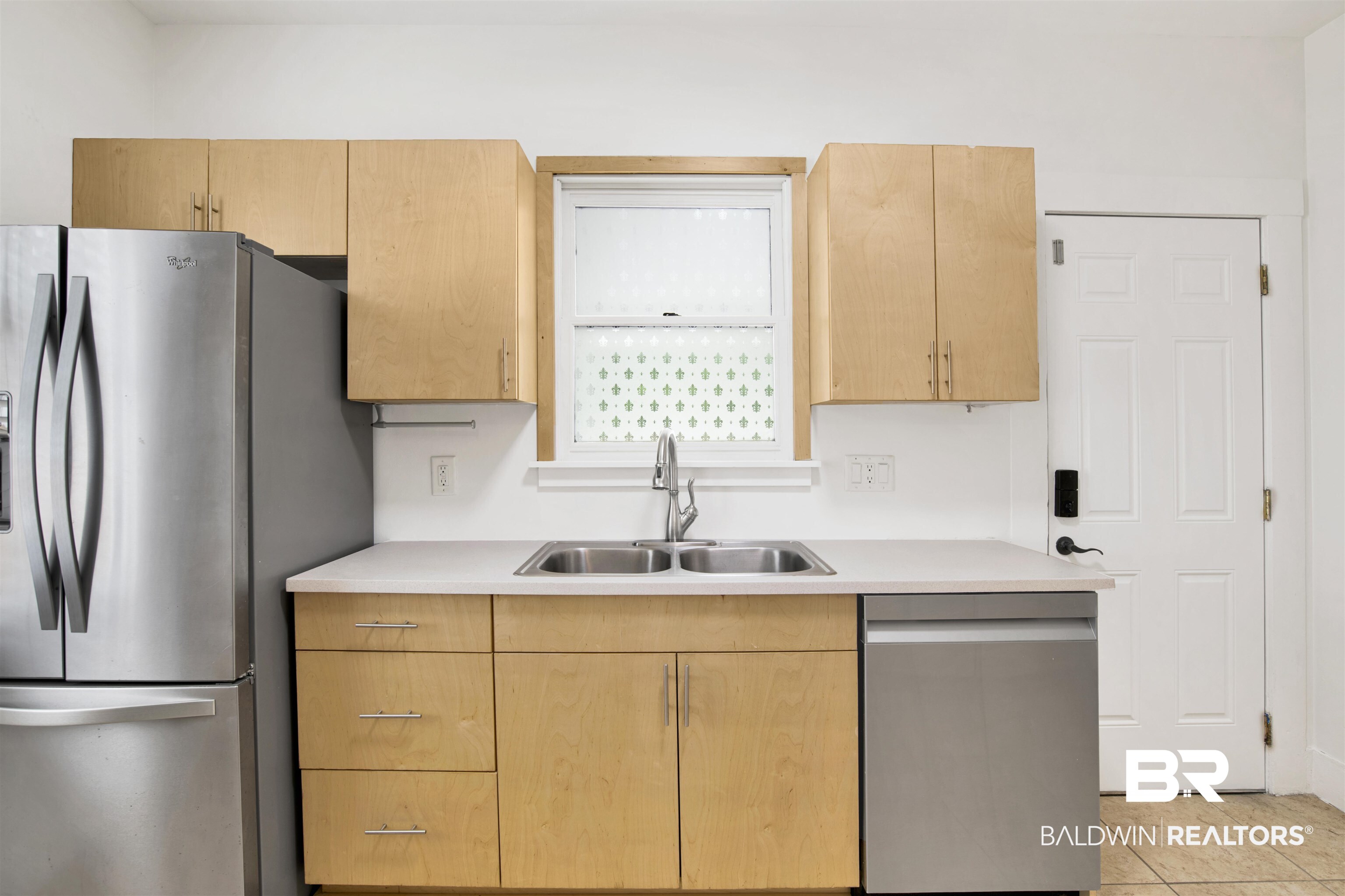 507 Holcombe Avenue Mobile, AL 36606 - Photo 11 of 28 Kitchen featuring stainless steel appliances, a sink, light countertops, and light tile patterned floors
