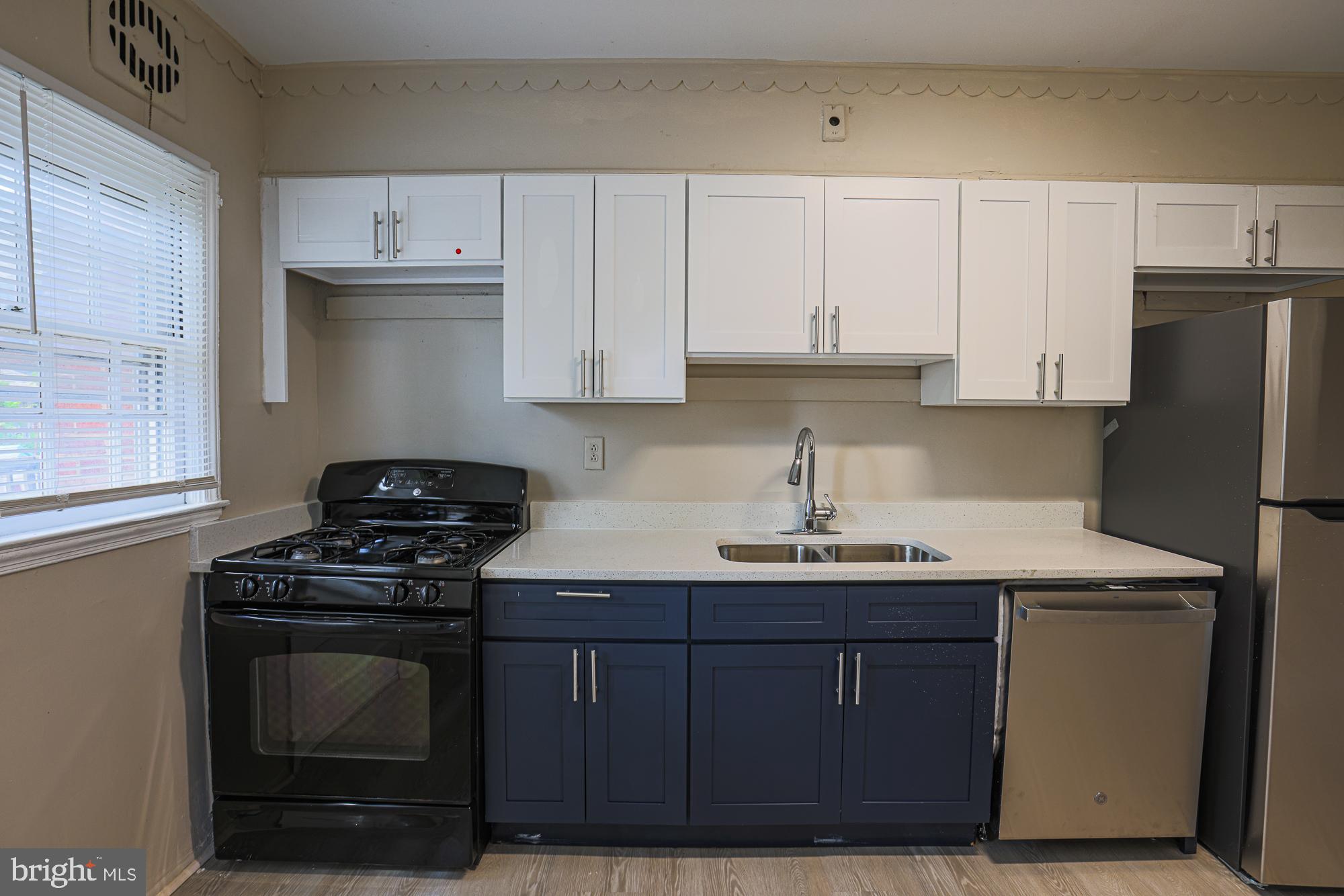 3914 Bancroft Road Baltimore, MD 21215 - Photo 13 of 25 a kitchen with stainless steel appliances a stove a sink and a refrigerator
