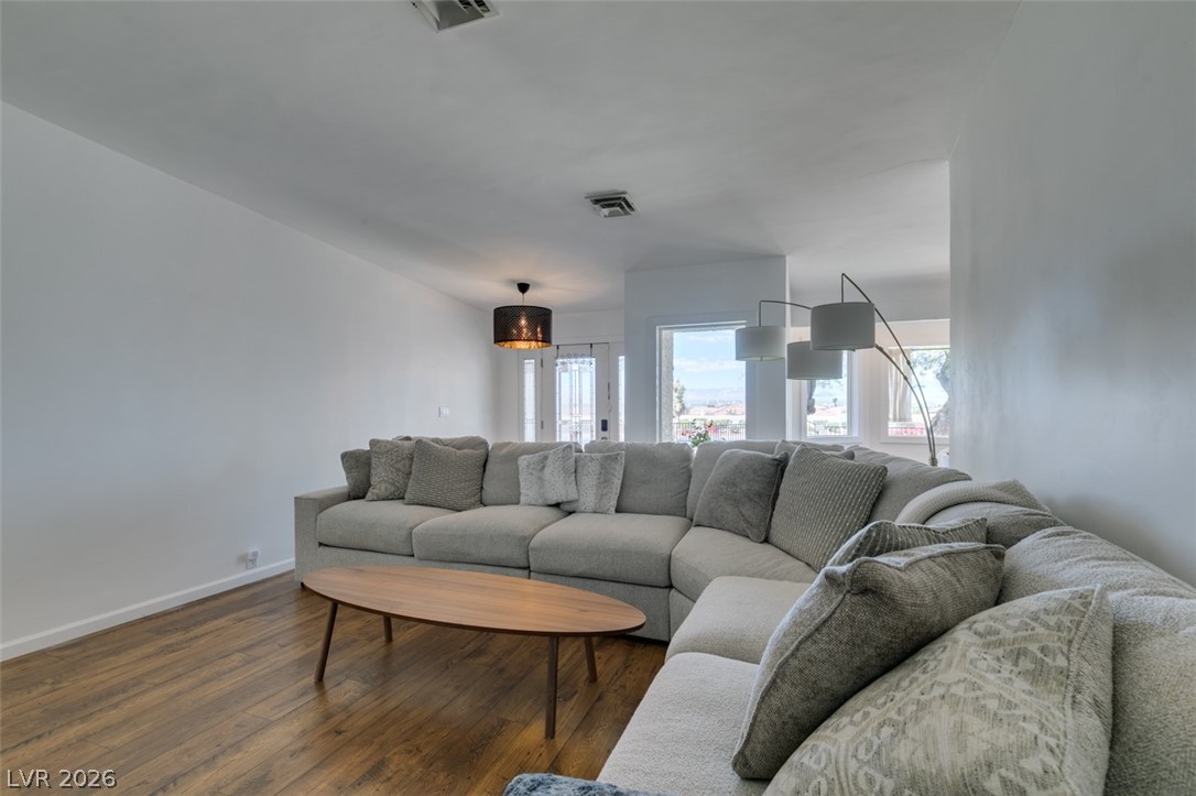 892 North Hollywood Boulevard Las Vegas, NV 89110 - Photo 16 of 81 This bright living space features wood flooring and large windows, offering ample natural light.