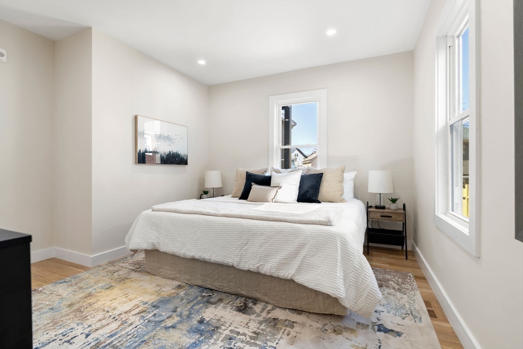 10 Marion Road, Unit 1 Belmont, MA 02478 - Photo 12 of 26 a bed room with a bed and a painting on the wall