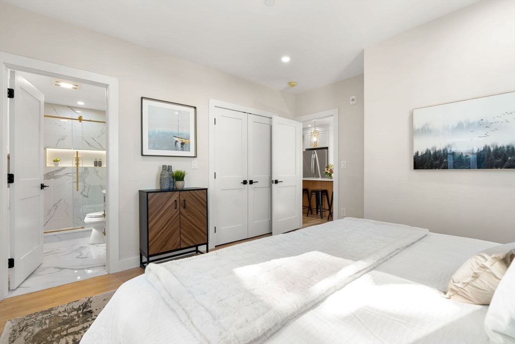 10 Marion Road, Unit 1 Belmont, MA 02478 - Photo 13 of 26 a bedroom with a bed and a couch