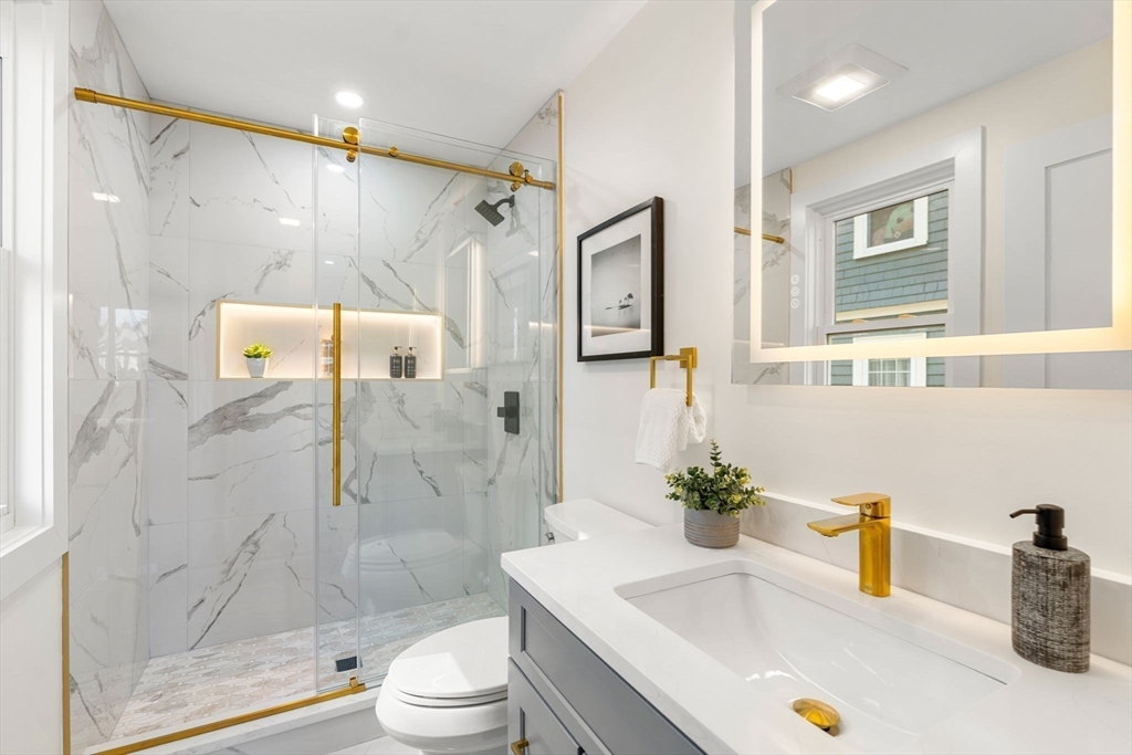 10 Marion Road, Unit 1 Belmont, MA 02478 - Photo 14 of 26 a bathroom with a sink a toilet and shower