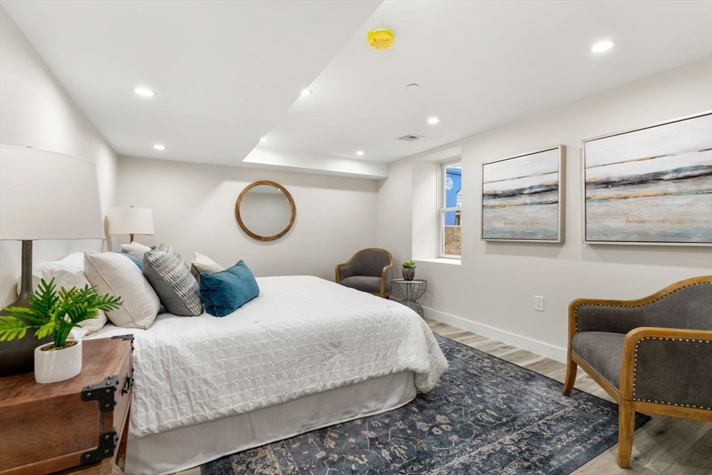 10 Marion Road, Unit 1 Belmont, MA 02478 - Photo 20 of 26 a bedroom with a bed couch and window