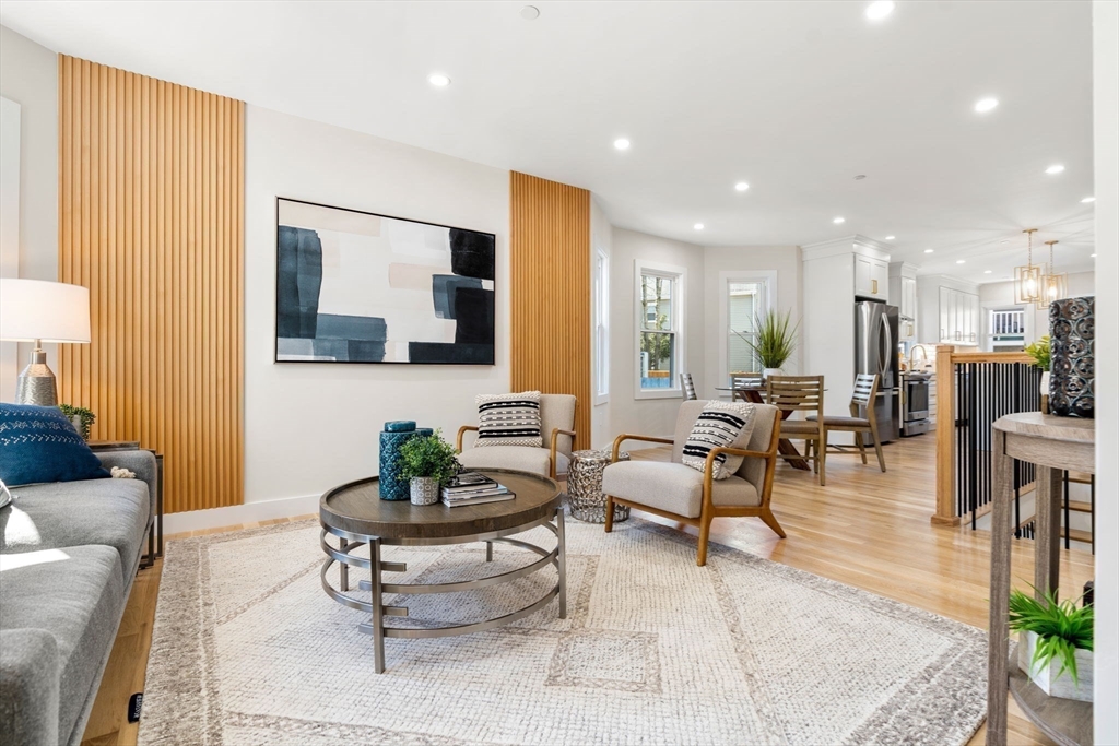 10 Marion Road, Unit 1 Belmont, MA 02478 - Photo 2 of 26 a living room with furniture and a view of kitchen