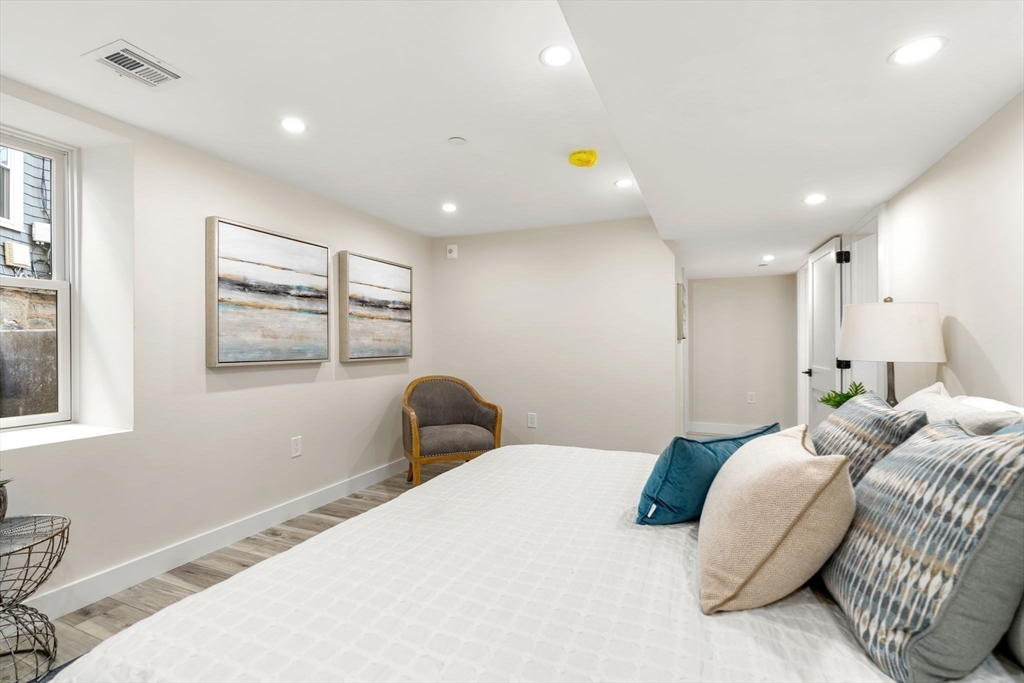 10 Marion Road, Unit 1 Belmont, MA 02478 - Photo 21 of 26 a bedroom with a bed and wooden floor