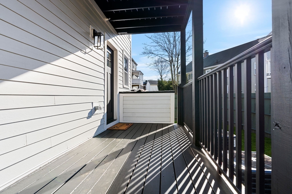 10 Marion Road, Unit 1 Belmont, MA 02478 - Photo 24 of 26 a view of a balcony with wooden floor