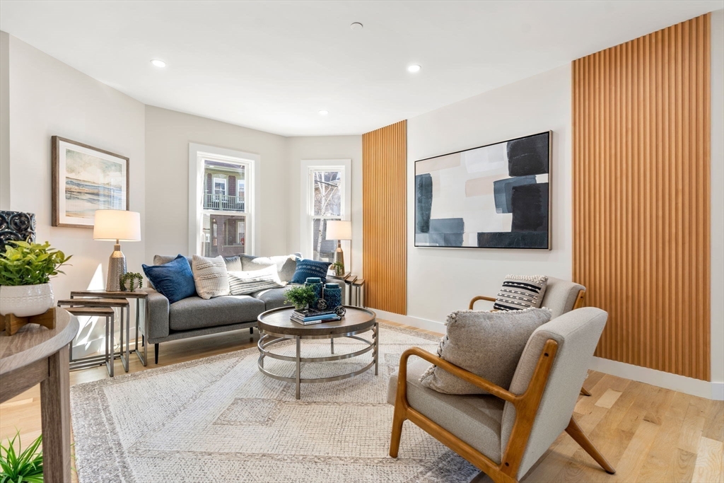 10 Marion Road, Unit 1 Belmont, MA 02478 - Photo 3 of 26 a living room with furniture and a flat screen tv