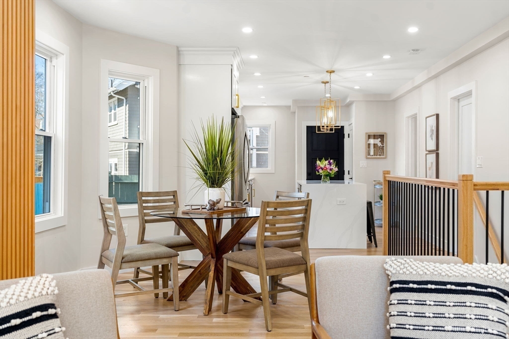 10 Marion Road, Unit 1 Belmont, MA 02478 - Photo 4 of 26 a view of a dining room with furniture and a flat screen tv