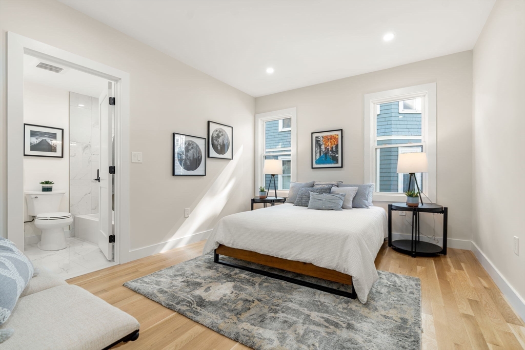 10 Marion Road, Unit 1 Belmont, MA 02478 - Photo 8 of 26 a spacious bedroom with a bed and a couch