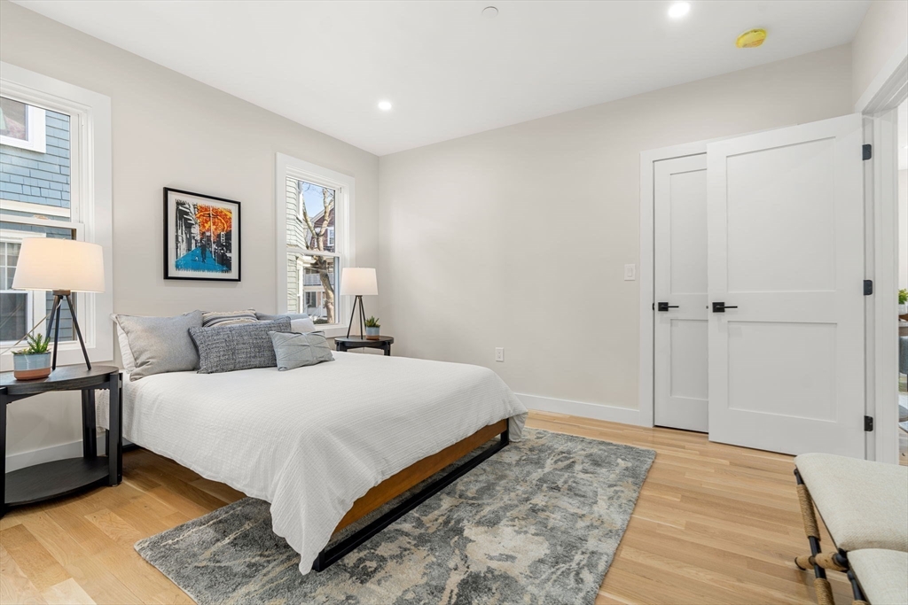 10 Marion Road, Unit 1 Belmont, MA 02478 - Photo 9 of 26 a bedroom with a large bed and a couch