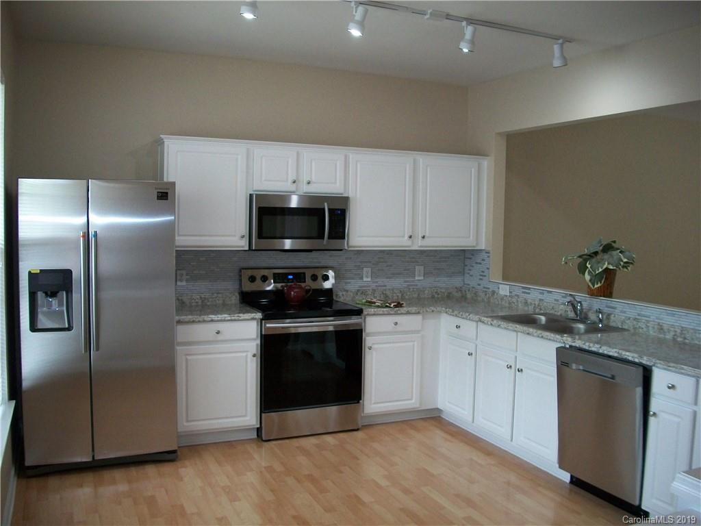 6646 Rothchild Drive Charlotte, NC 28270 - Photo 2 of 23 a kitchen with stainless steel appliances granite countertop a stove a sink and a refrigerator