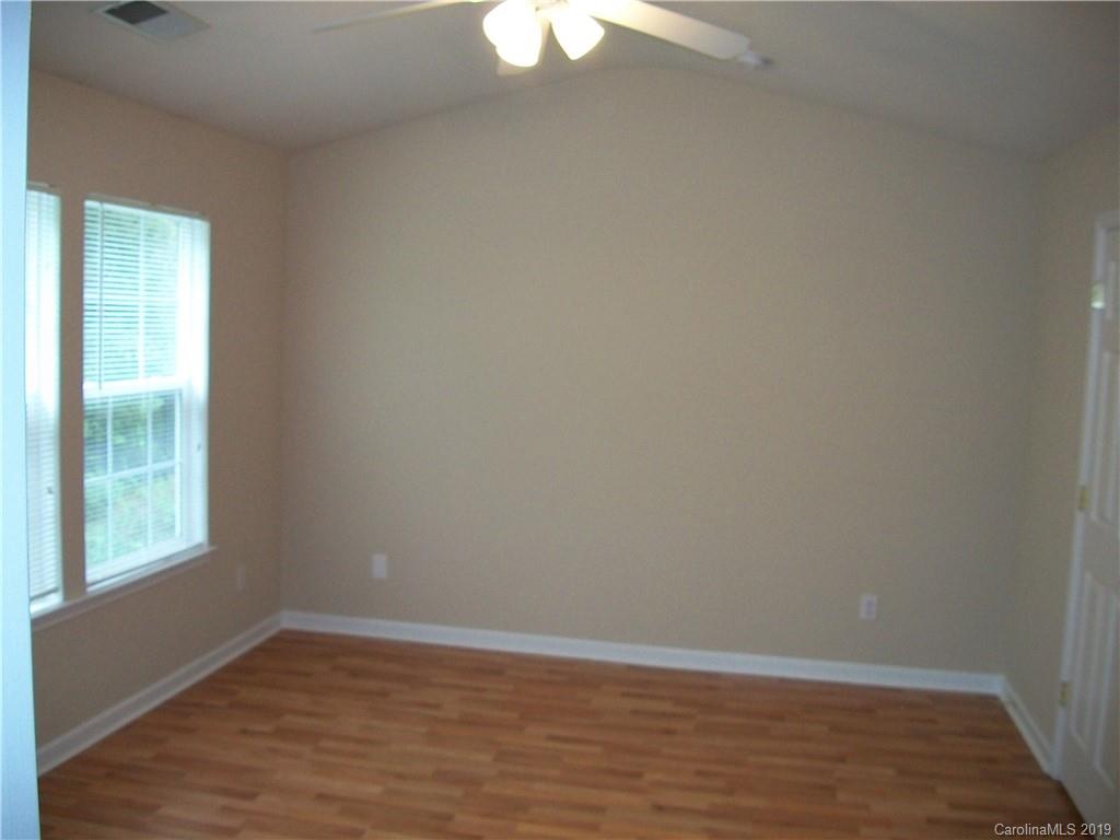 6646 Rothchild Drive Charlotte, NC 28270 - Photo 11 of 23 a view of an empty room with wooden floor and a window