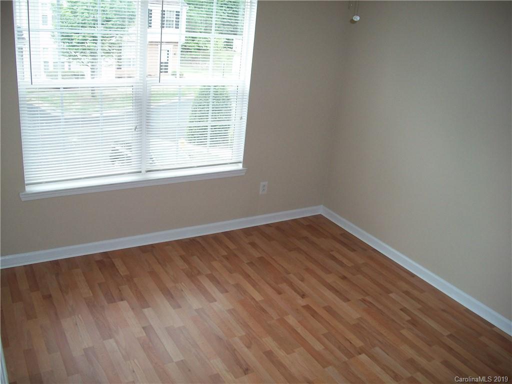 6646 Rothchild Drive Charlotte, NC 28270 - Photo 17 of 23 an empty room with wooden floor and windows