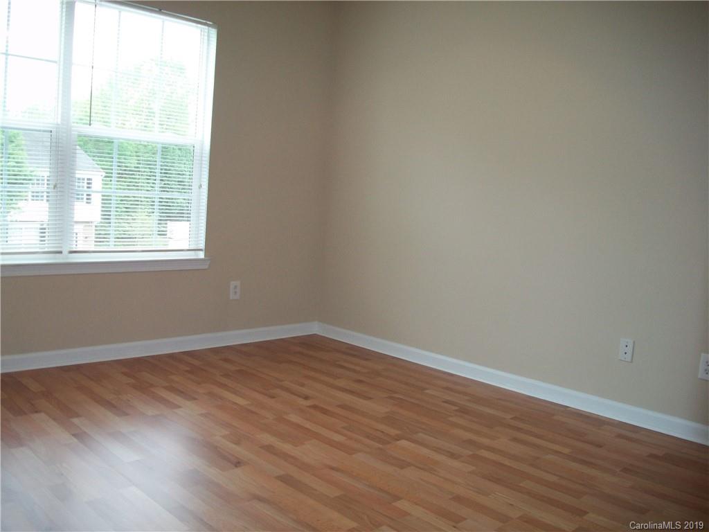 6646 Rothchild Drive Charlotte, NC 28270 - Photo 18 of 23 an empty room with wooden floor and windows