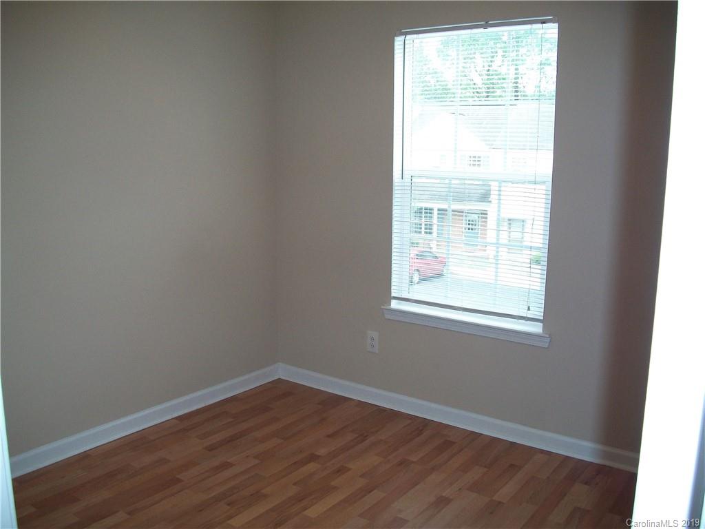 6646 Rothchild Drive Charlotte, NC 28270 - Photo 19 of 23 an empty room with wooden floor and windows