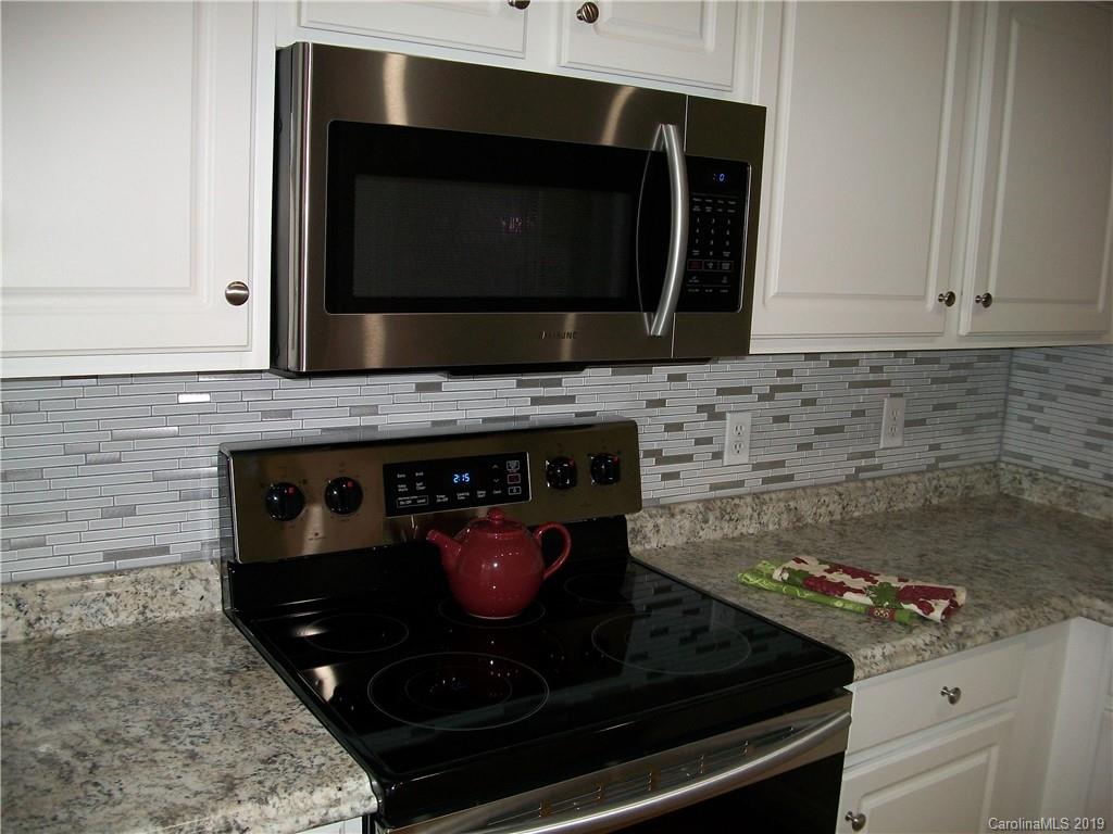 6646 Rothchild Drive Charlotte, NC 28270 - Photo 3 of 23 a kitchen with a stove and a microwave