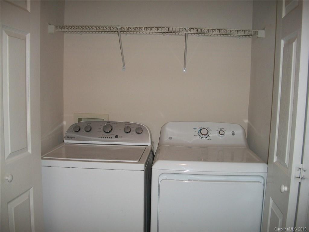 6646 Rothchild Drive Charlotte, NC 28270 - Photo 21 of 23 a view of storage and utility room with washer and dryer