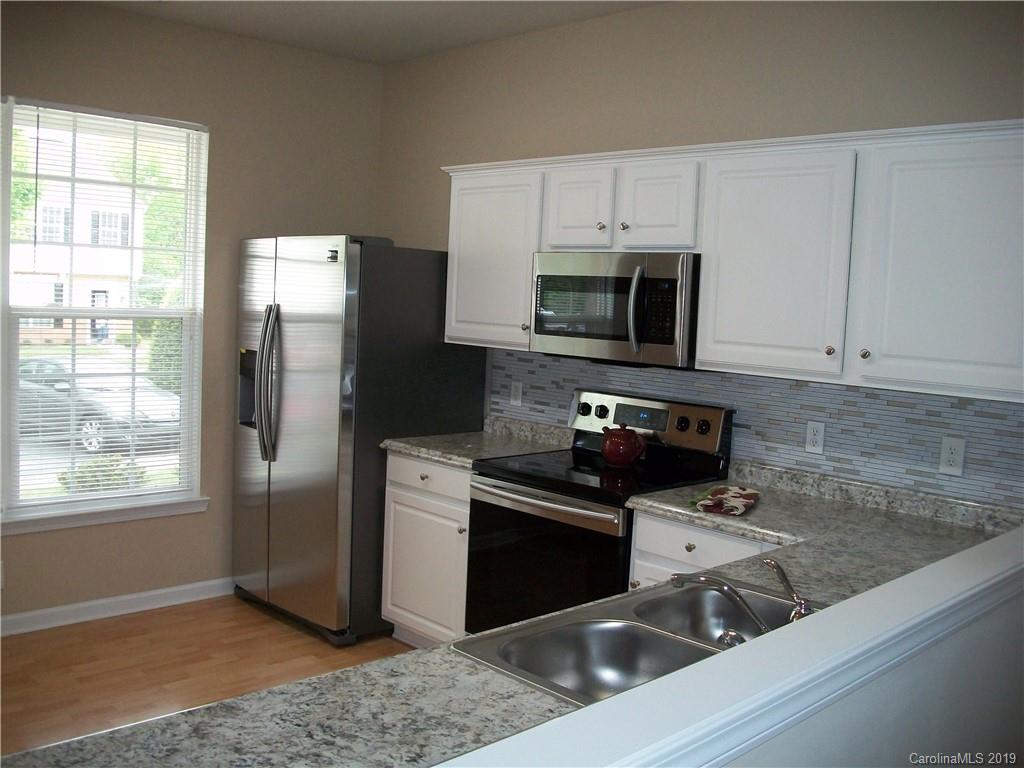 6646 Rothchild Drive Charlotte, NC 28270 - Photo 4 of 23 a kitchen with a refrigerator stove and microwave