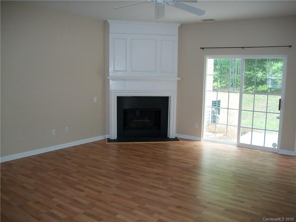 6646 Rothchild Drive Charlotte, NC 28270 - Photo 6 of 23 a view of an empty room with wooden floor and a window
