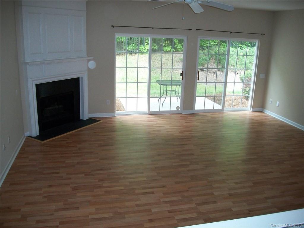 6646 Rothchild Drive Charlotte, NC 28270 - Photo 7 of 23 a view of an empty room with a fireplace and a window