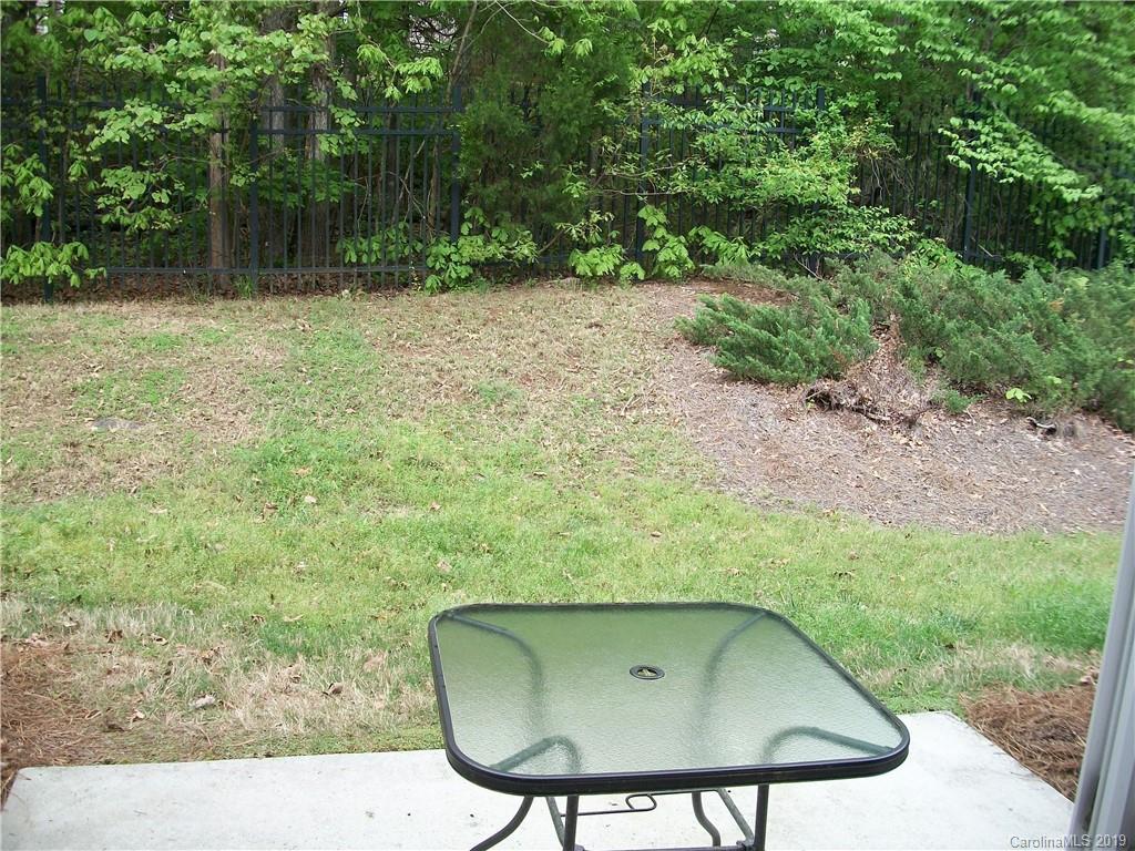 6646 Rothchild Drive Charlotte, NC 28270 - Photo 9 of 23 a backyard of a house with green landscape