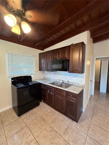 a kitchen with stainless steel appliances granite countertop wooden cabinets a sink and dishwasher