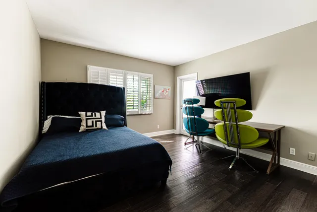 a bedroom with a bed a table and chair