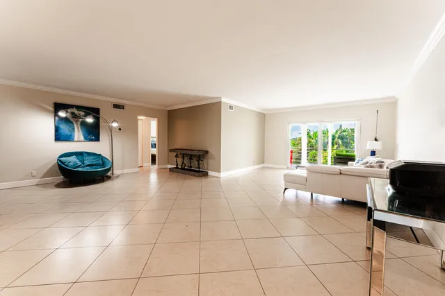 a living room with furniture a window and a table