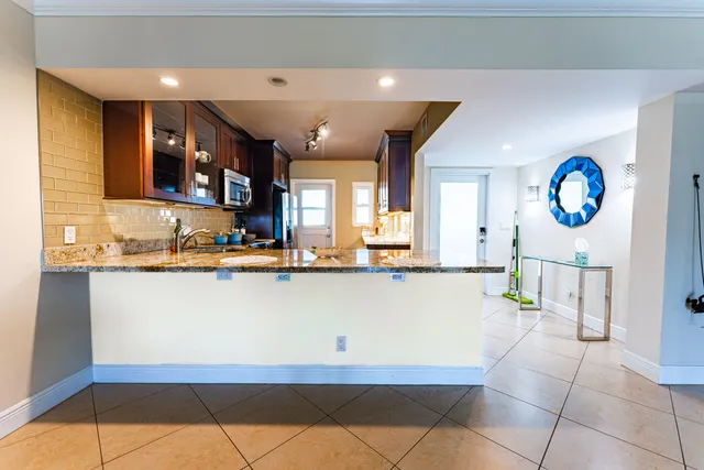 a large white kitchen with a large window