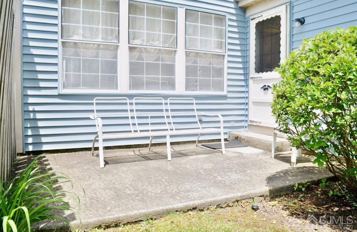 171 Concordia Circle, Unit C Monroe Township, NJ 08831 - Photo 12 of 13 a house with a window and table in front