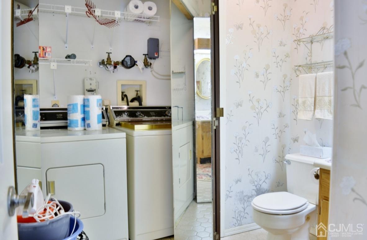171 Concordia Circle, Unit C Monroe Township, NJ 08831 - Photo 7 of 13 a bathroom with a toilet a sink and a mirror